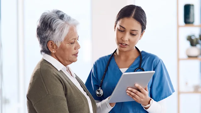 Health: Senior health: woman reading test results 1169325038