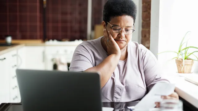 glp-1-agonists: woman reading paperwork 2166297109
