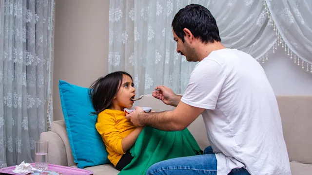 infections: father feeding daughter soup 1462713205