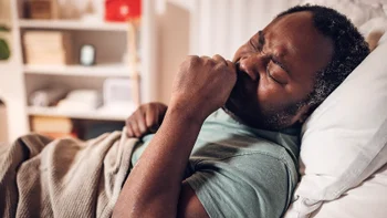 Cold-symptoms: man in bed coughing 2032936637