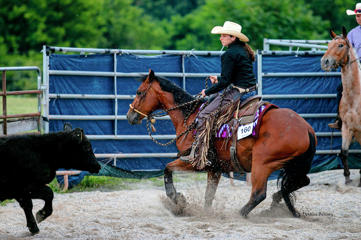 Kaleigh Canfield, pictured in a white cowboy hat on a brown horse, competes in reined cow horse events.