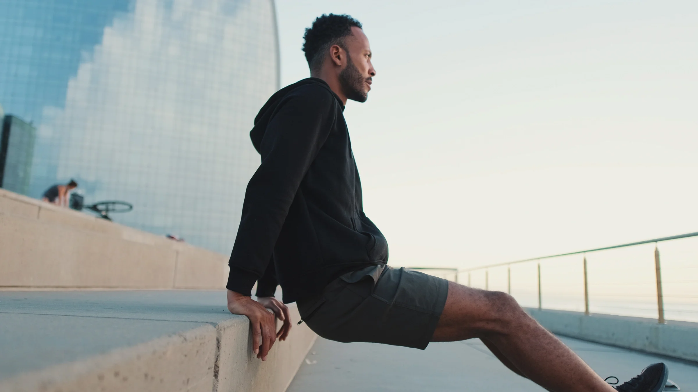 Man doing tricep dip exercise outdoors