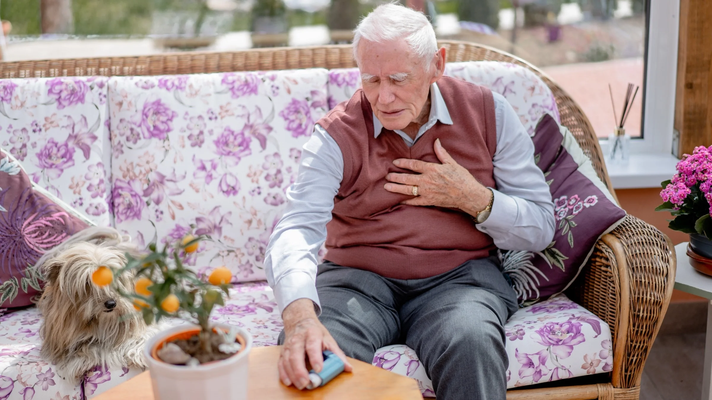 An older man reaching for an inhaler.