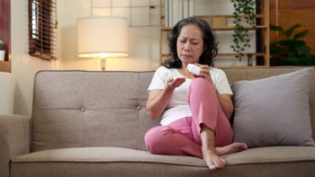 Pharmacy: woman taking medication at home 1692409221