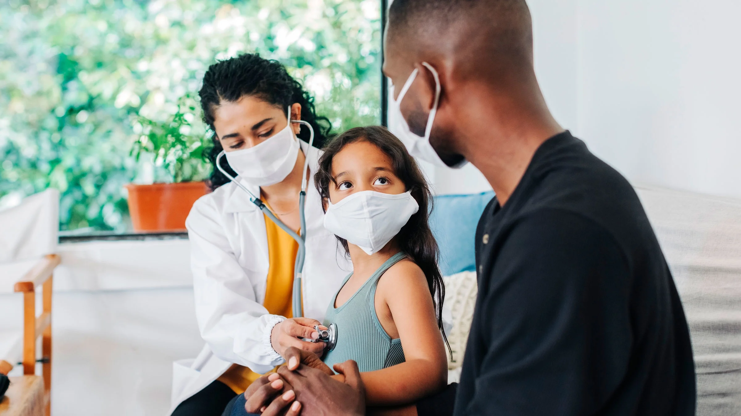 A child is at a healthcare appointment with a mask on.