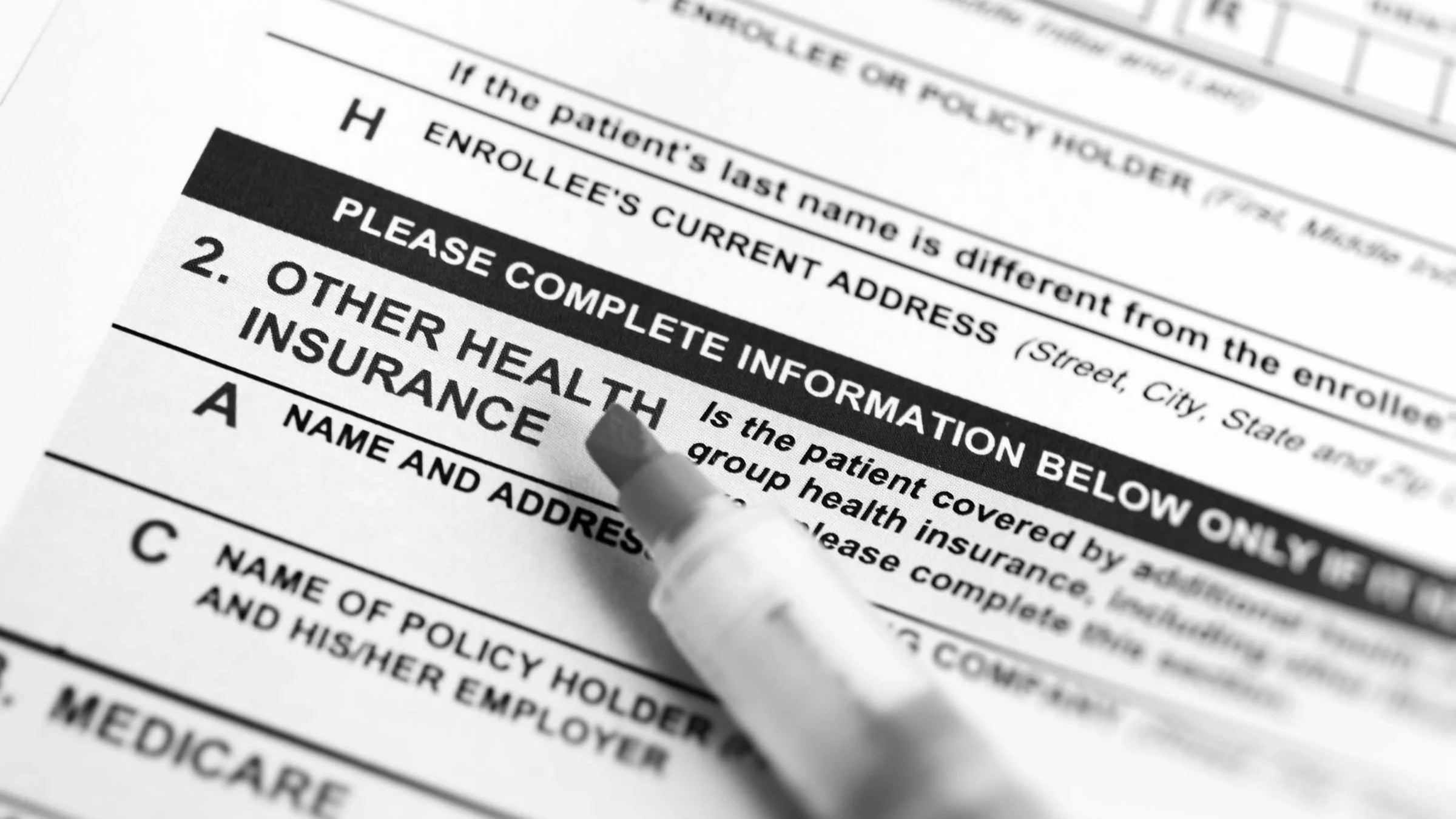 A pen and the insurance field of a health form.