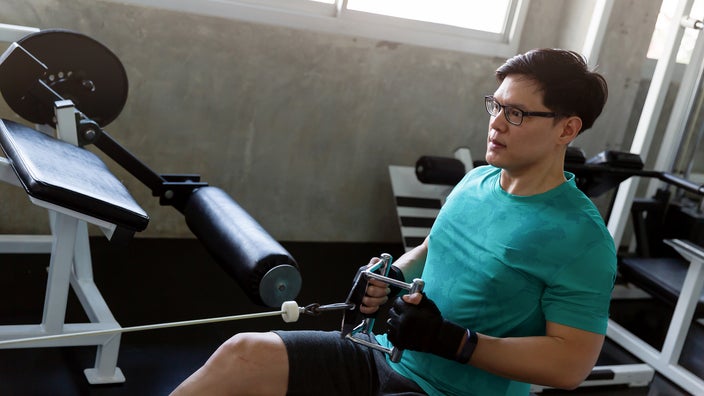 A man uses a machine at the gym.