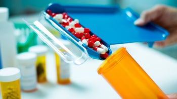 Pharmacies: pharmacy filling pill bottle 168410026