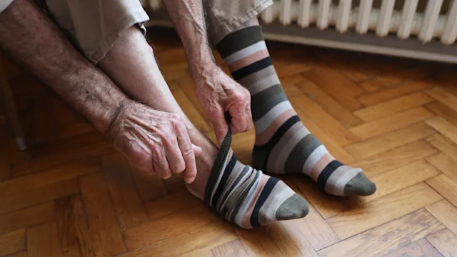 Health: Fungal infection: closeup man taking off socks 1279220557