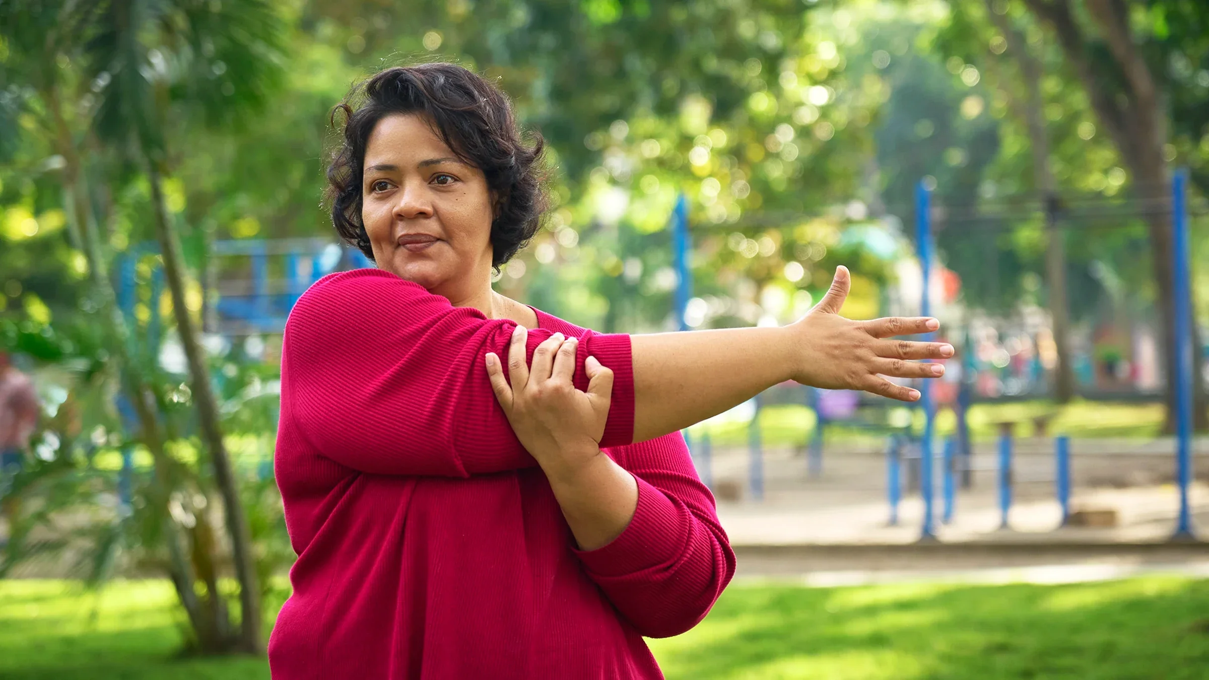 Woman stretching in the park.
apomares/E+ via Getty Images