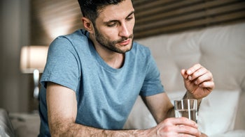Chantix: man taking medication with glass of water 1212245228