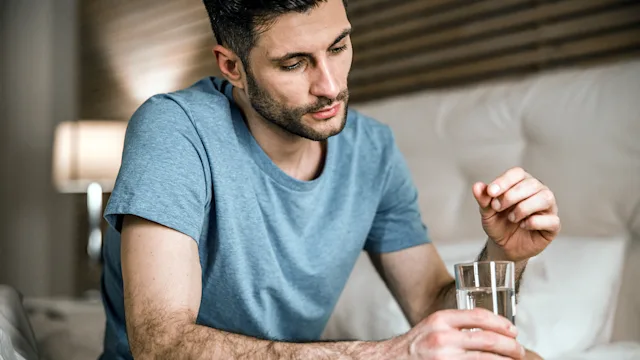 Chantix: man taking medication with glass of water 1212245228