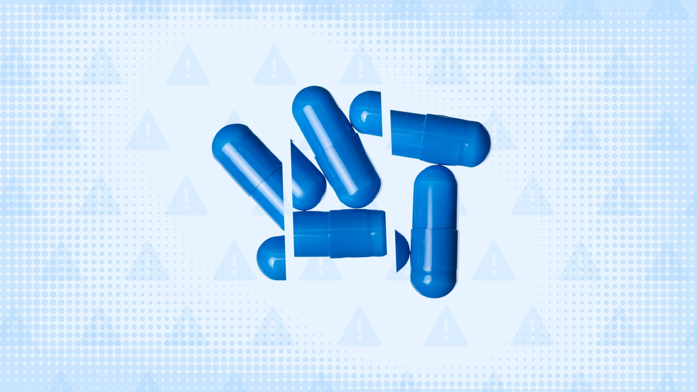 In the center of a light blue background with texture and warning sign pattern is a pile of blue capsule pills cut into thirds. 