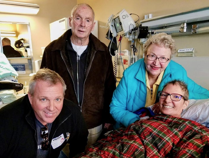 Dave Dondoneau in a hospital room with his parents, Vern and Joan Dondoneau, and his sister, Julie Dondaneau. 