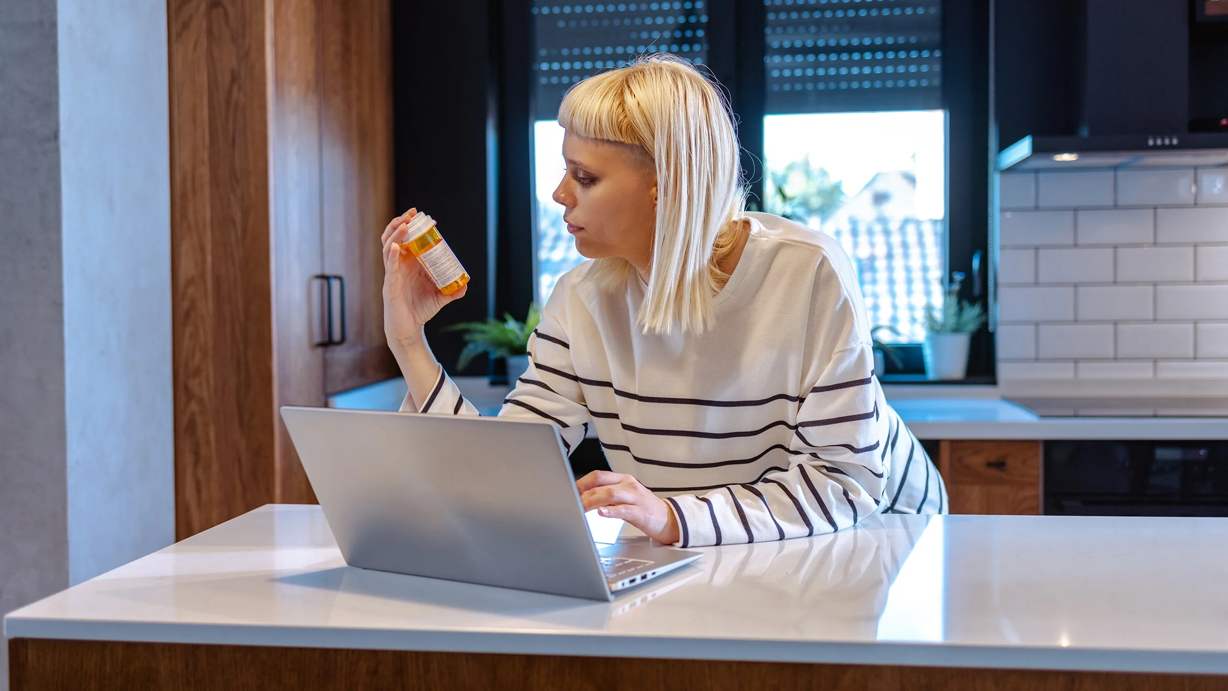 A woman is researching medication on her computer.