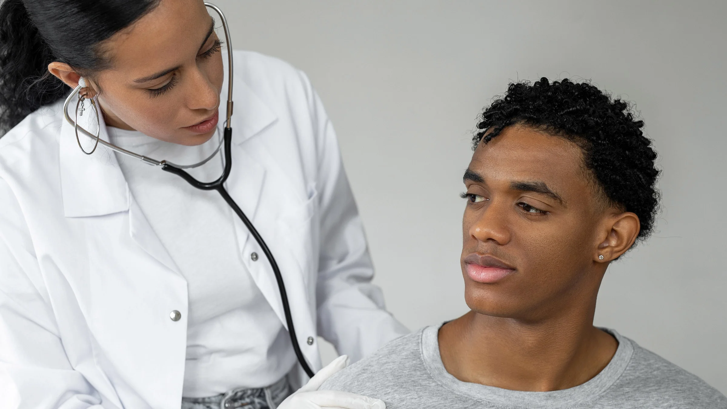 A doctor listening to a patient's lungs.