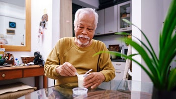 Gut Health: Diet Nutrition: senior man eating yogurt 1482254850