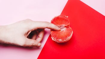 Sexual health: still life orgasm concept hand and grapefruit 1129643399