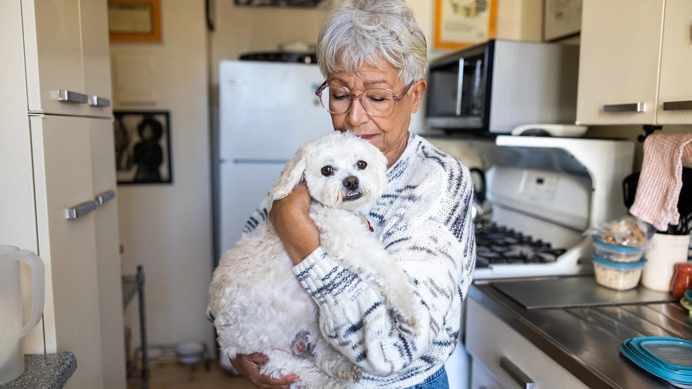 Older woman holding her dog.