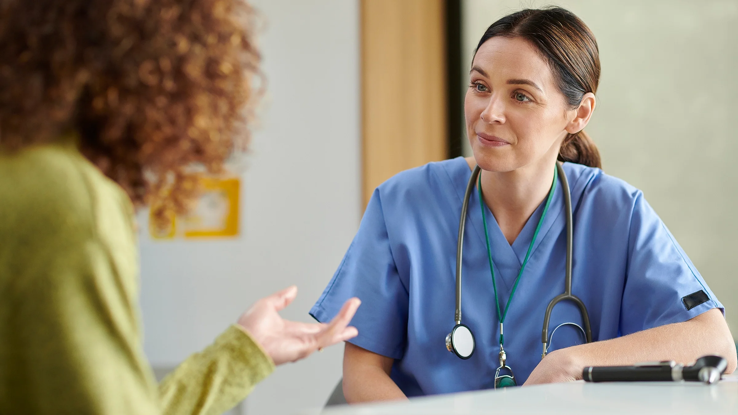 A healthcare professional speaks to a patient.