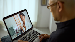 A man speaks to a doctor during a telemedicine appointment.
Joy10000Lightpower/E+ via Getty Images
