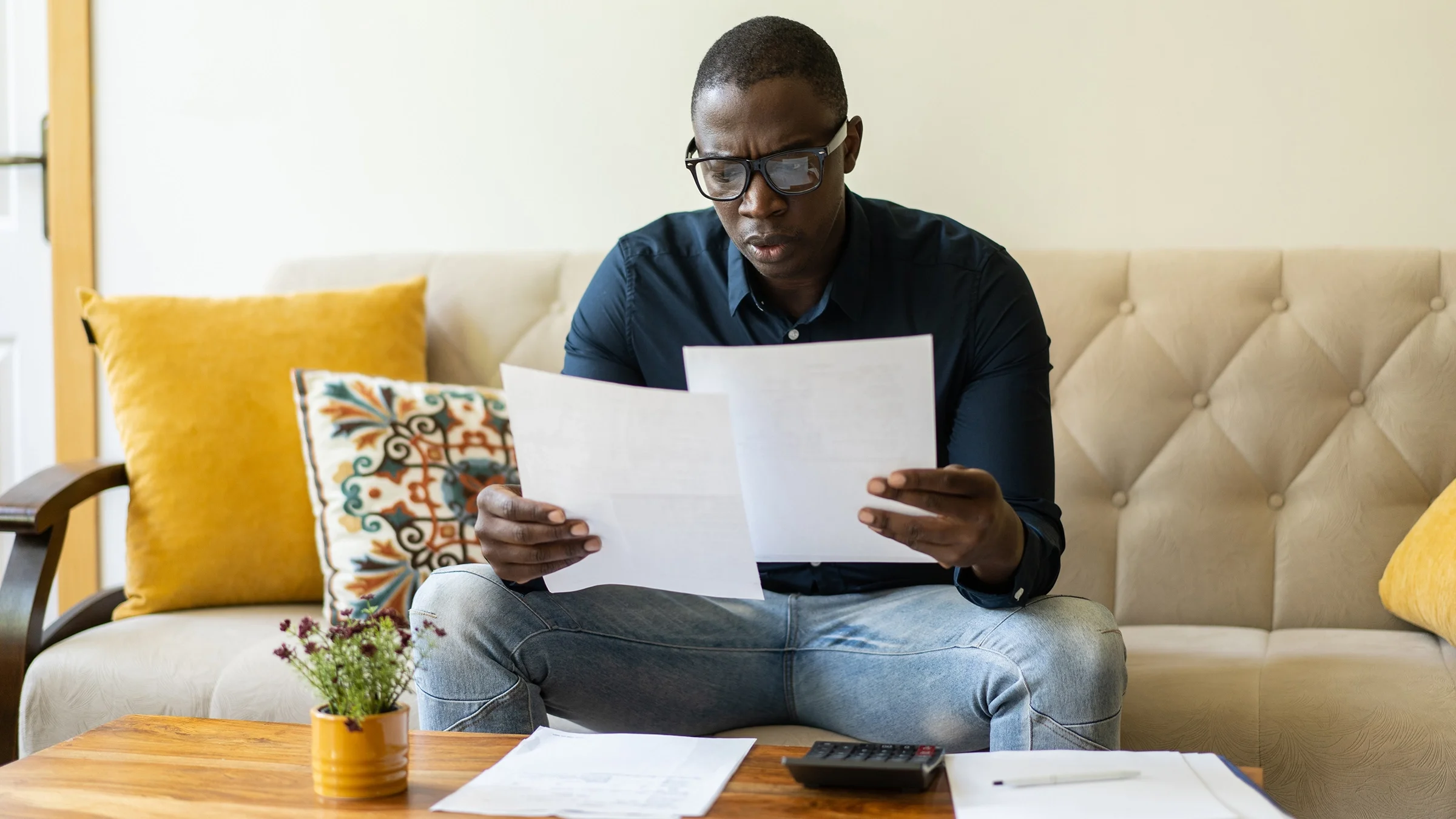 Man reviewing expenses at home.