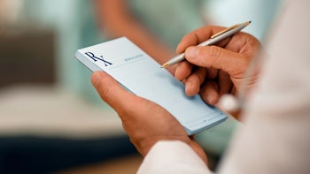 Pharmacists: holding prescription pad and pen 669638328