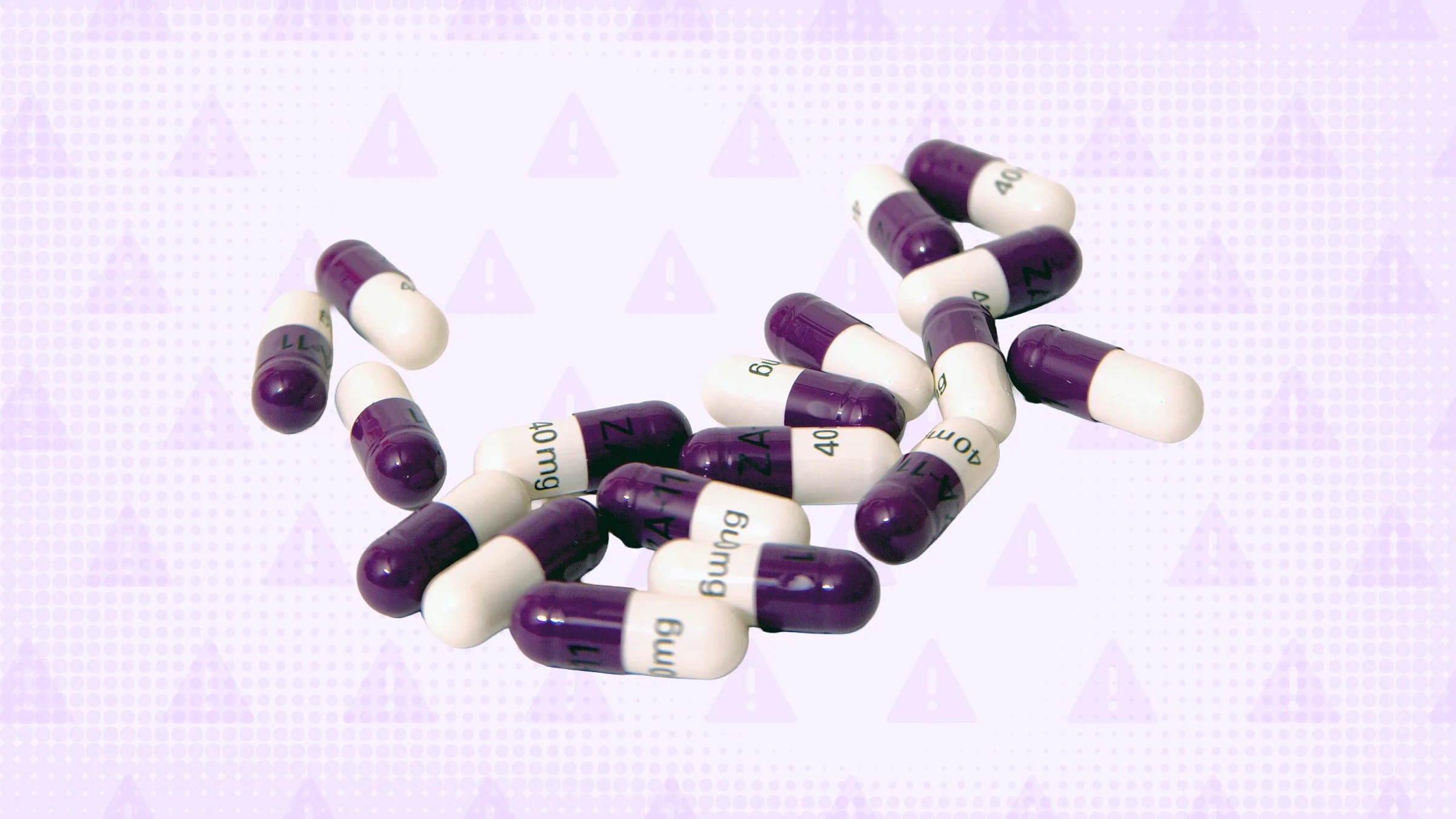 A pile of white and purple capsule pills is pictured against a light-purple, warning-sign background.