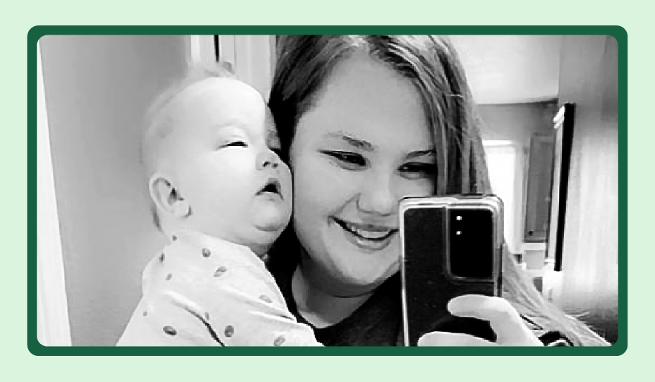 Emily Pierzina is pictured in a selfie, holding her infant son.