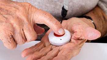 Digital-Health: closeup senior woman pressing alarm button 838500250