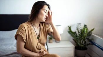 shingles: woman with a headache 2225282852