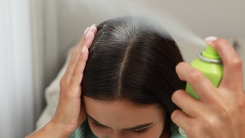 Hair: woman using dry shampoo 1331250679
