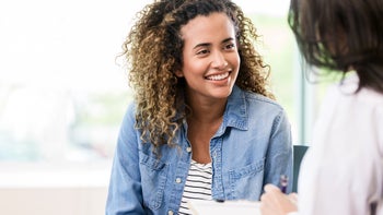 Birth Control: woman smiling at medical appointment 1271564879