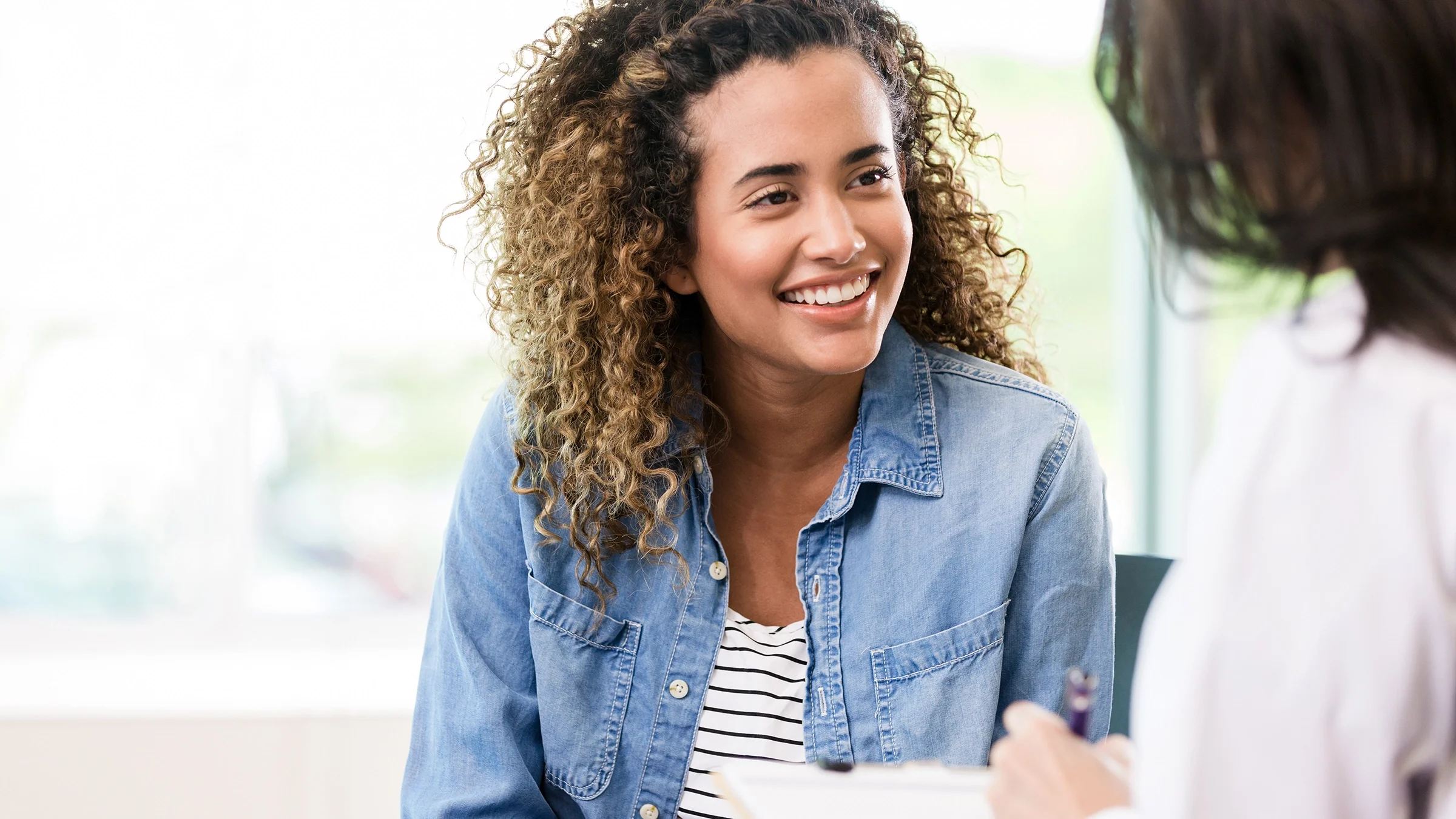 A woman smiles during a medical appointment.