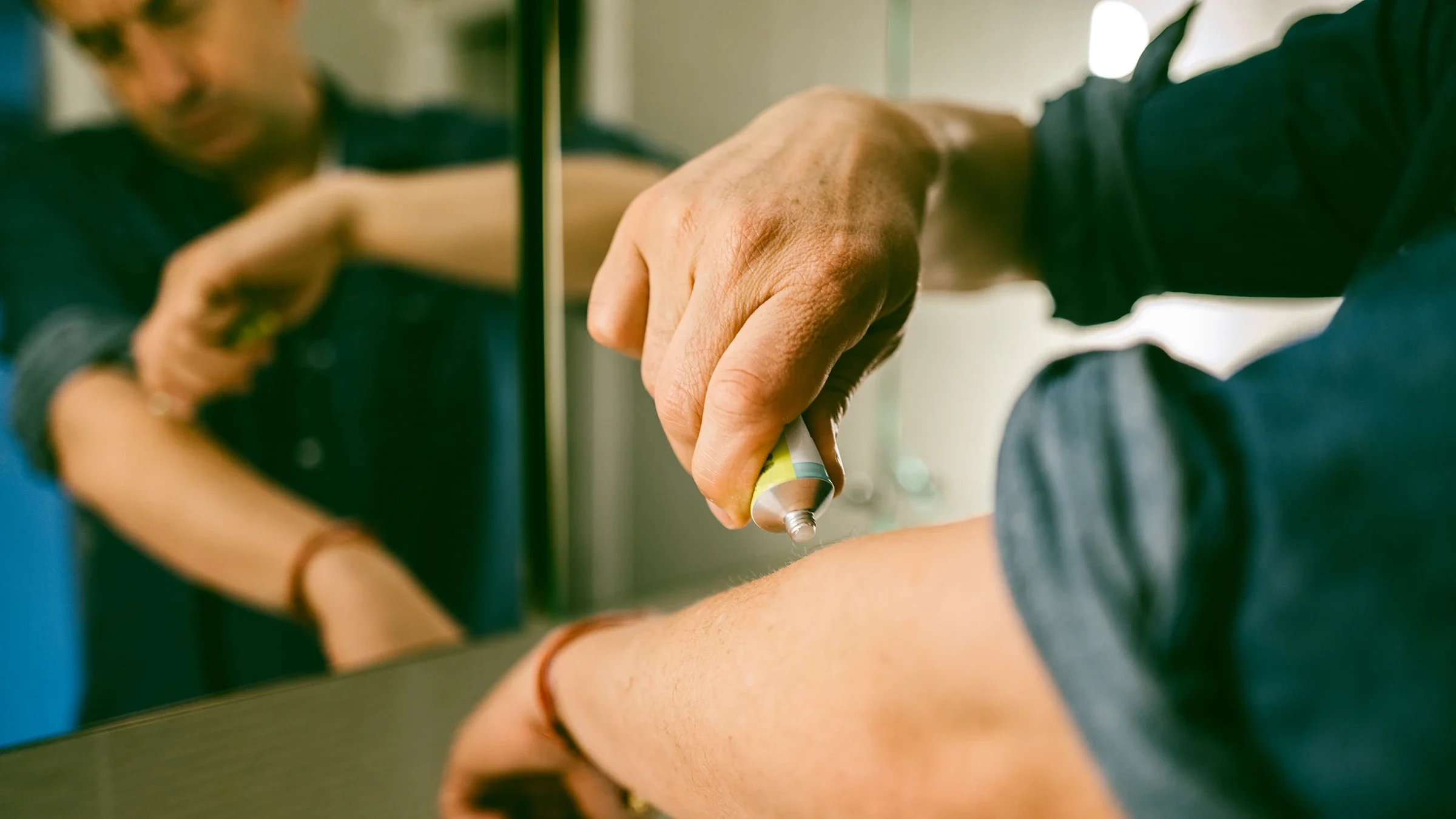 A man applies topical cream.