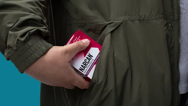 Narcan: hand placing narcan in pocket CourtesyofEmergent
