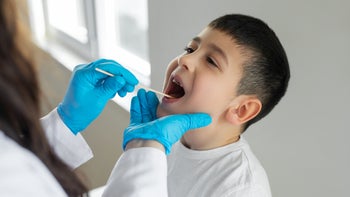 Children's Health: boy having throat exam 1482806770