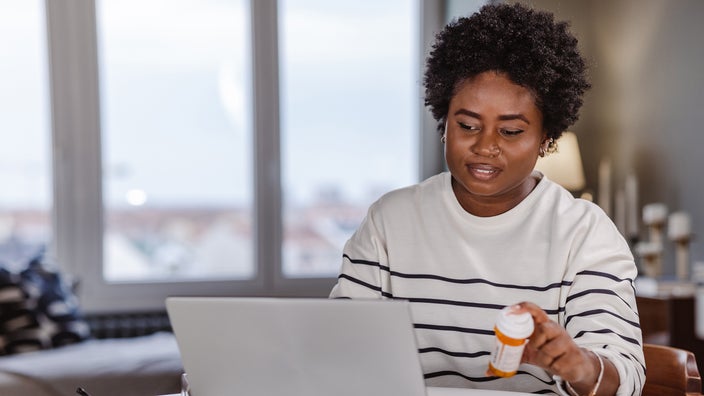 A woman searches for information about her medicine online.