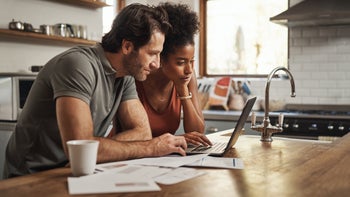 Health: FSA/HSA: couple reviewing taxes on laptop 1294144617