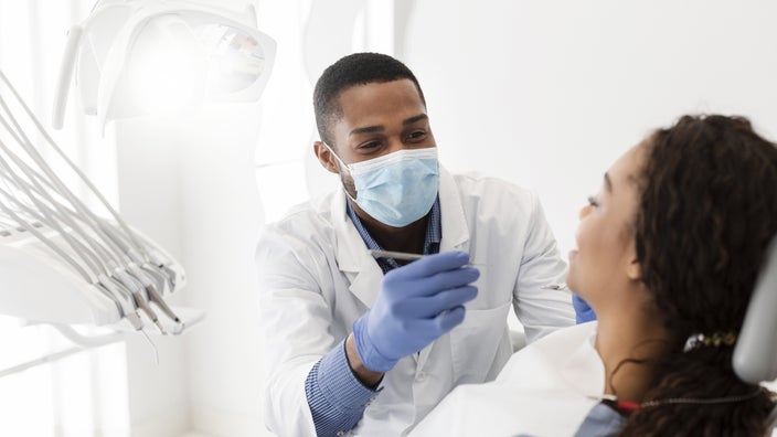 A dentist is working with a patient during an appointment.