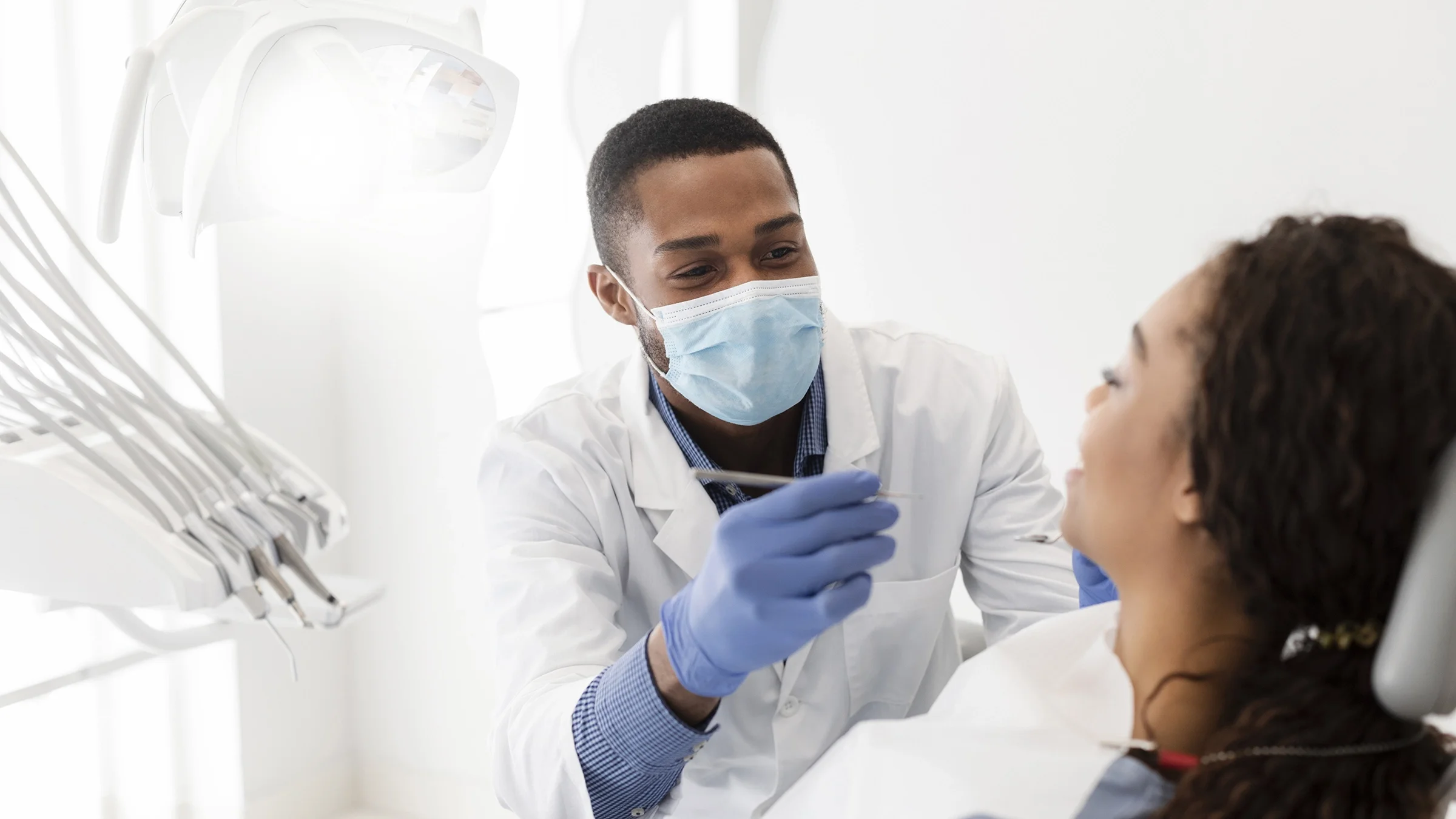 A dentist is working with a patient during an appointment.