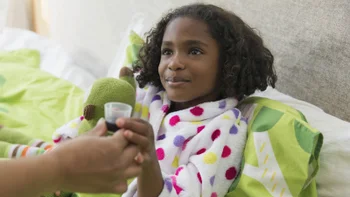 Children's Health: child taking medicine in bed 1430839287
