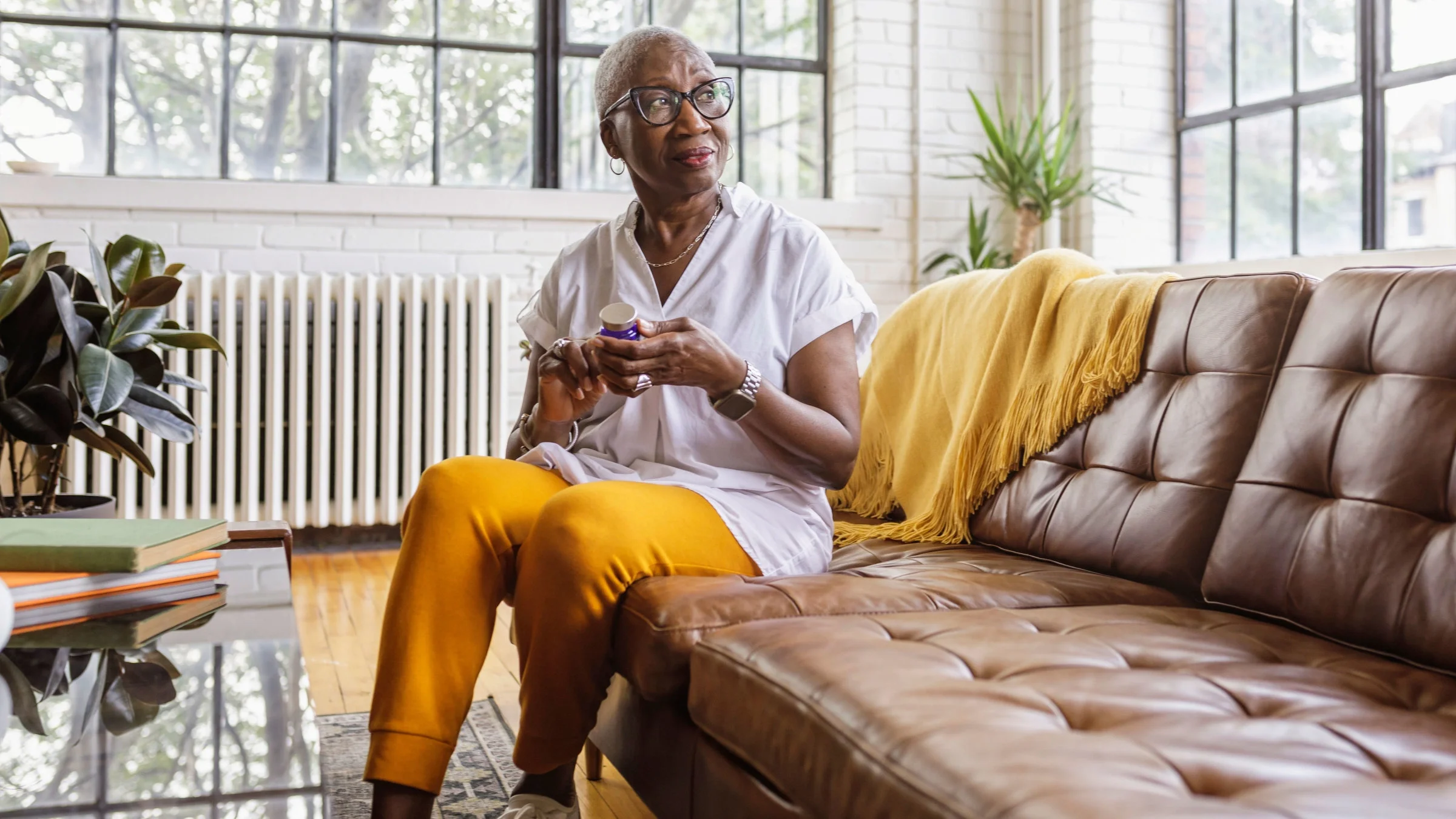 Woman taking medicine at home