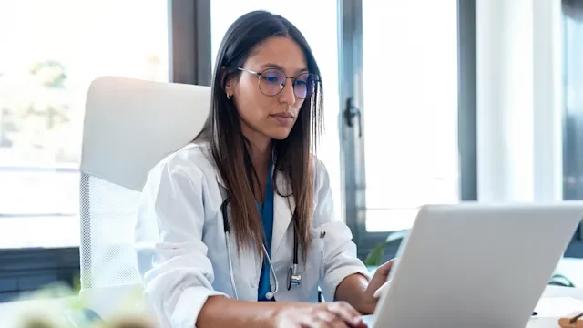 Health: Providers: doctor at laptop-1254443202