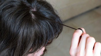 mental-health: close up woman pulling own hair-1135791792