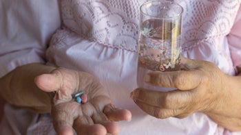 Health: Mesalamine: person holding pills water 1269886464