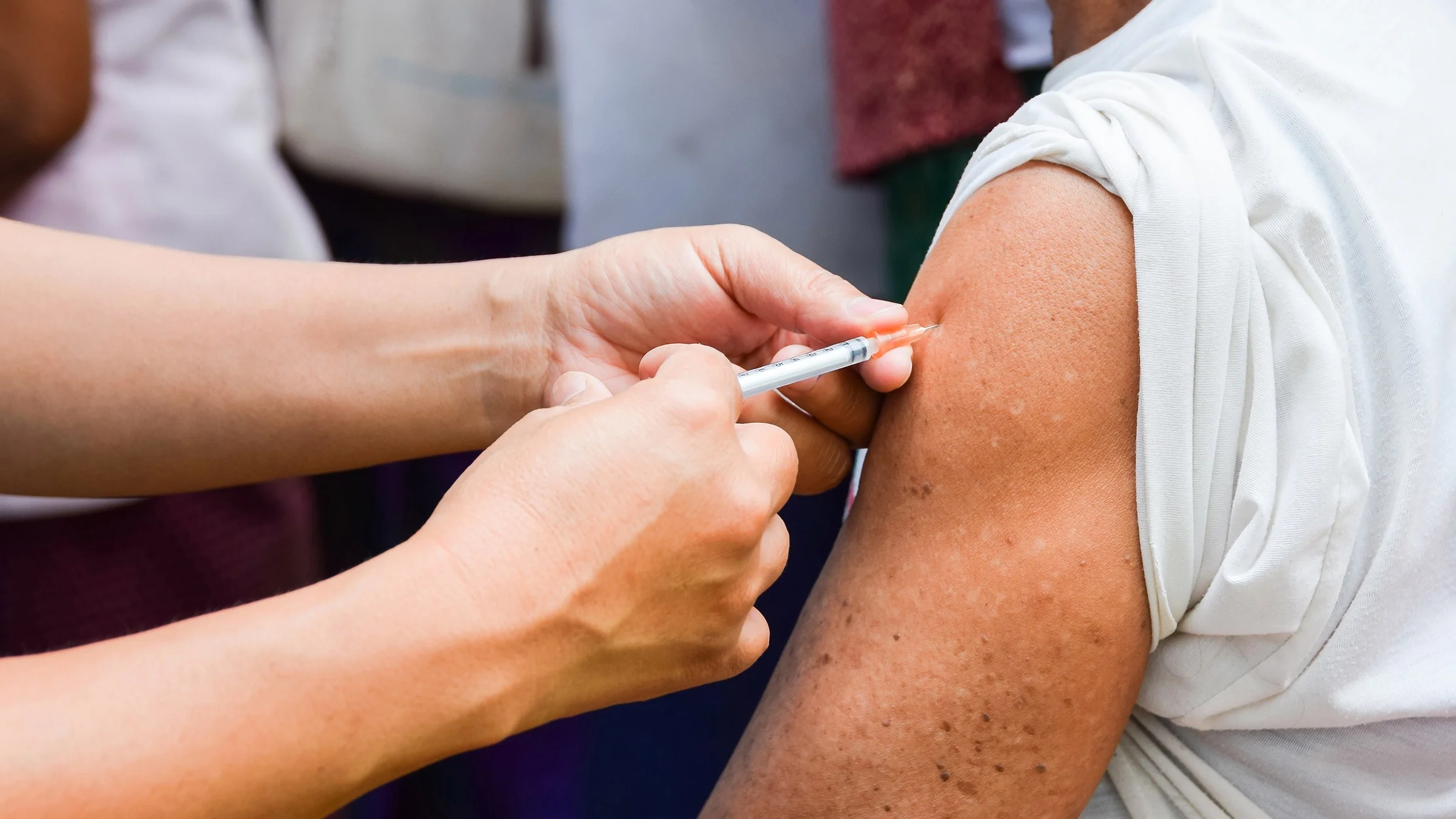 Cropped shot of a person receiving a vaccine.