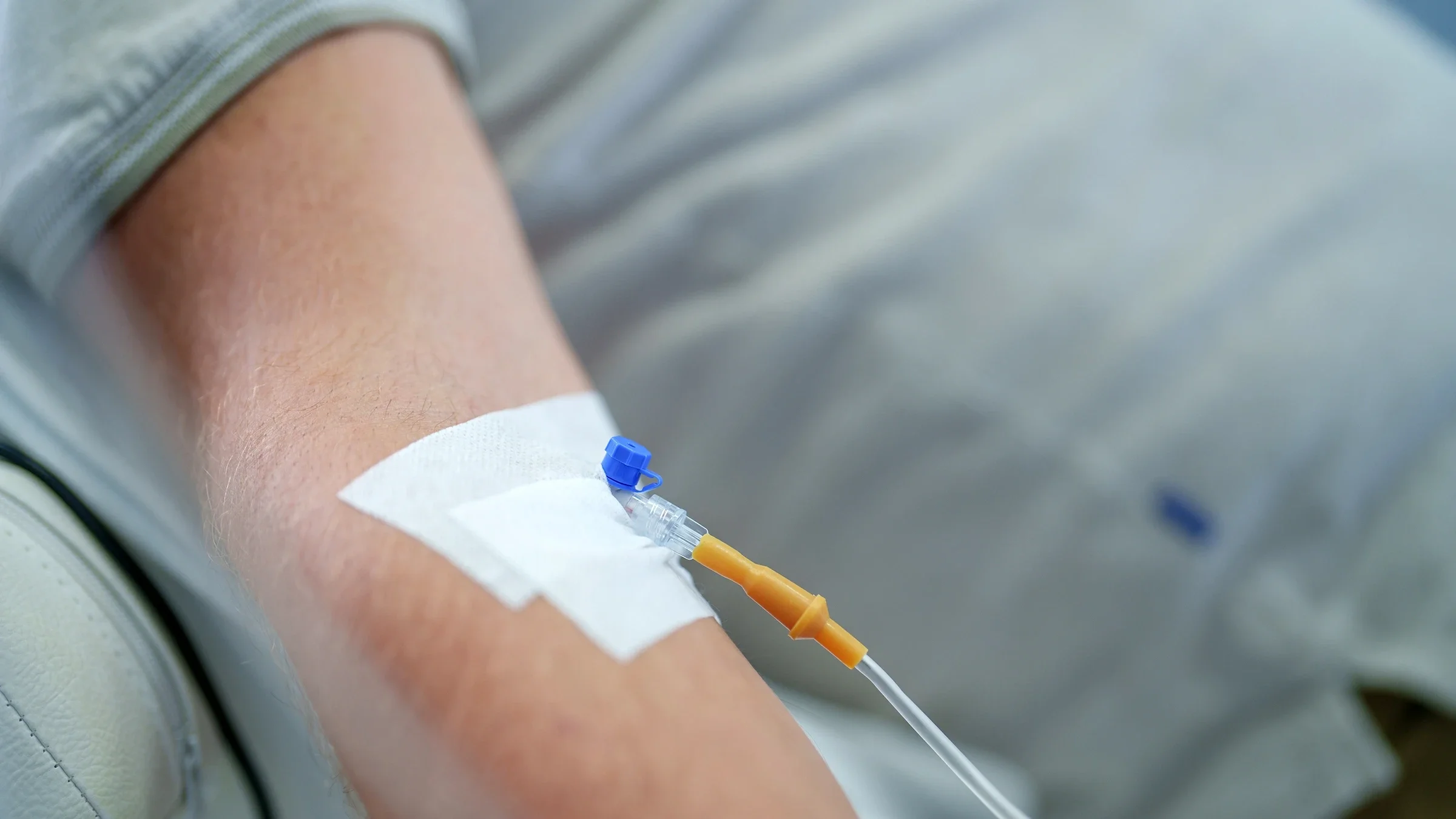 A close-up view shows a vein infusion in progress.