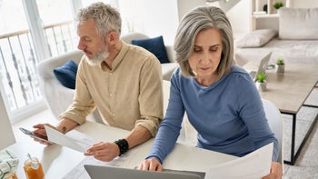 Health: Medical debt: senior couple calculating finances-1316483001