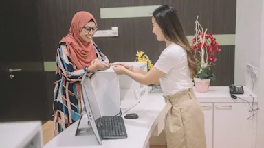 Health insurance: handing insurance card to receptionist 1202967426